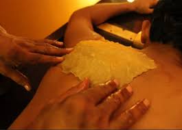 Pichu herbal paste application on the upper back
